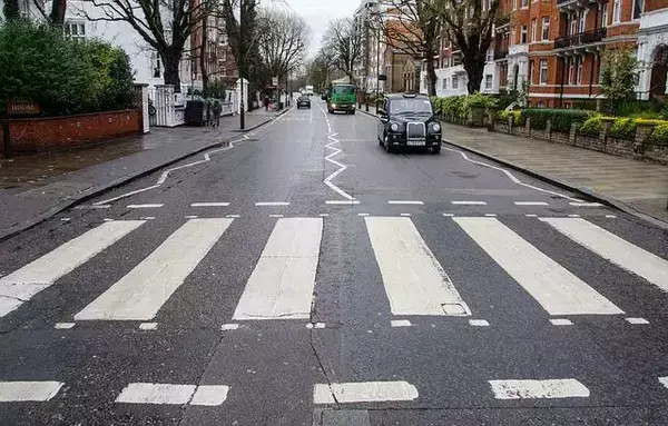 Faixa de pedestres da rua Abbey Road, famosa por estar em álbum dos Beatles