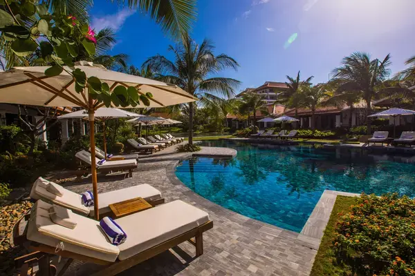 Cadeiras para tomar sol em frente a piscina de resort