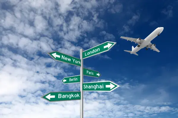 Um avião sobrevoando placas de destino