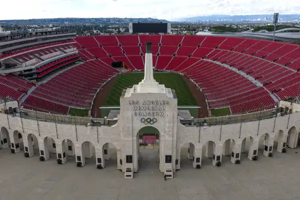 Vista do Los Angeles Memorial Coliseum iluminado e com grande público.